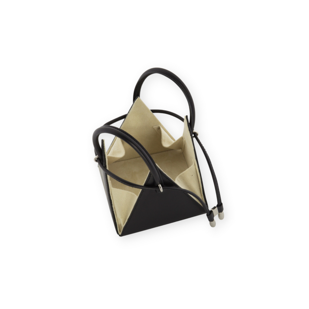 Buy now the Iconic LIA Mini Bag inspired by the geometric shapes of our designer's birth city Barcelona, and its world known artist, Antonio Gaudí, architect of the world wonder La Sagrada Familia. The Iconic Lia Black Mini Bag has a unique and functional pyramidal design able to fit all your essentials.