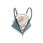 Buy now the Iconic LIA Mini bag inspired by the geometric shapes of our designer's birth city Barcelona, and its world known artist, Antonio Gaudí, architect of the world wonder La Sagrada Familia. The Iconic Lia Cipresso Green Mini bag has a unique and functional pyramidal design able to fit all your essentials.