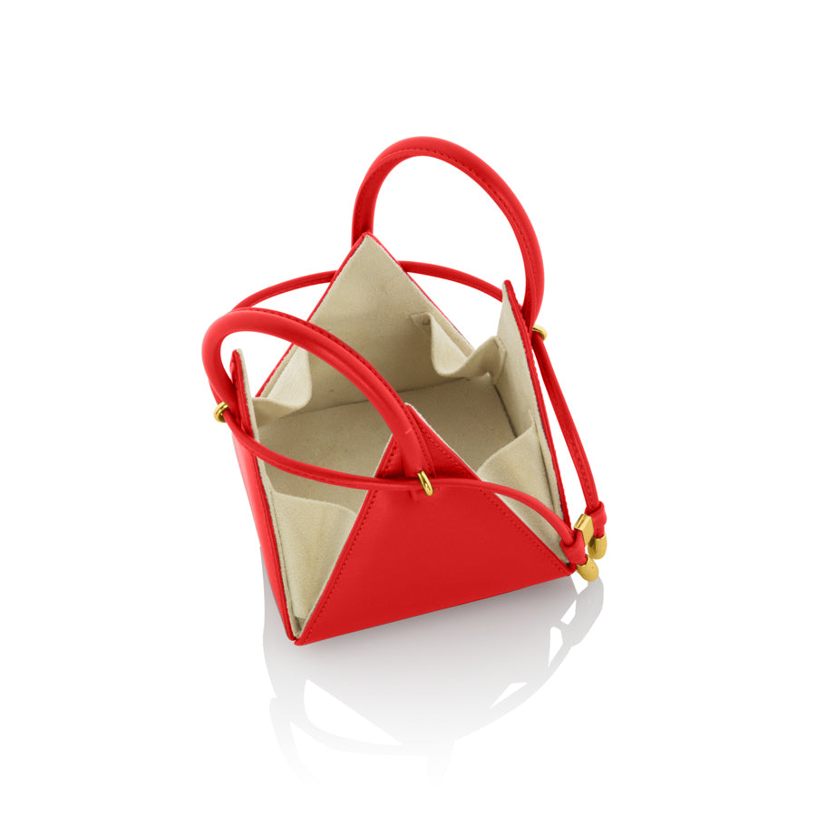 Buy now the Iconic LIA Mini bag inspired by the geometric shapes of our designer's birth city Barcelona, and its world known artist, Antonio Gaudí, architect of the world wonder La Sagrada Familia. The Iconic Lia Red Mini bag has a unique and functional pyramidal design able to fit all your essentials. 