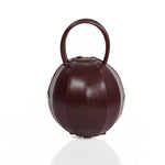 Buy now the Iconic Pilo Handbag inspired by the geometric shapes of our designer's birth city Barcelona, and its world known artist, Antonio Gaudí, architect of the world wonder La Sagrada Familia. The Iconic Pilo Burgundy Handbag has a unique and functional pyramidal design able to fit all your essentials.