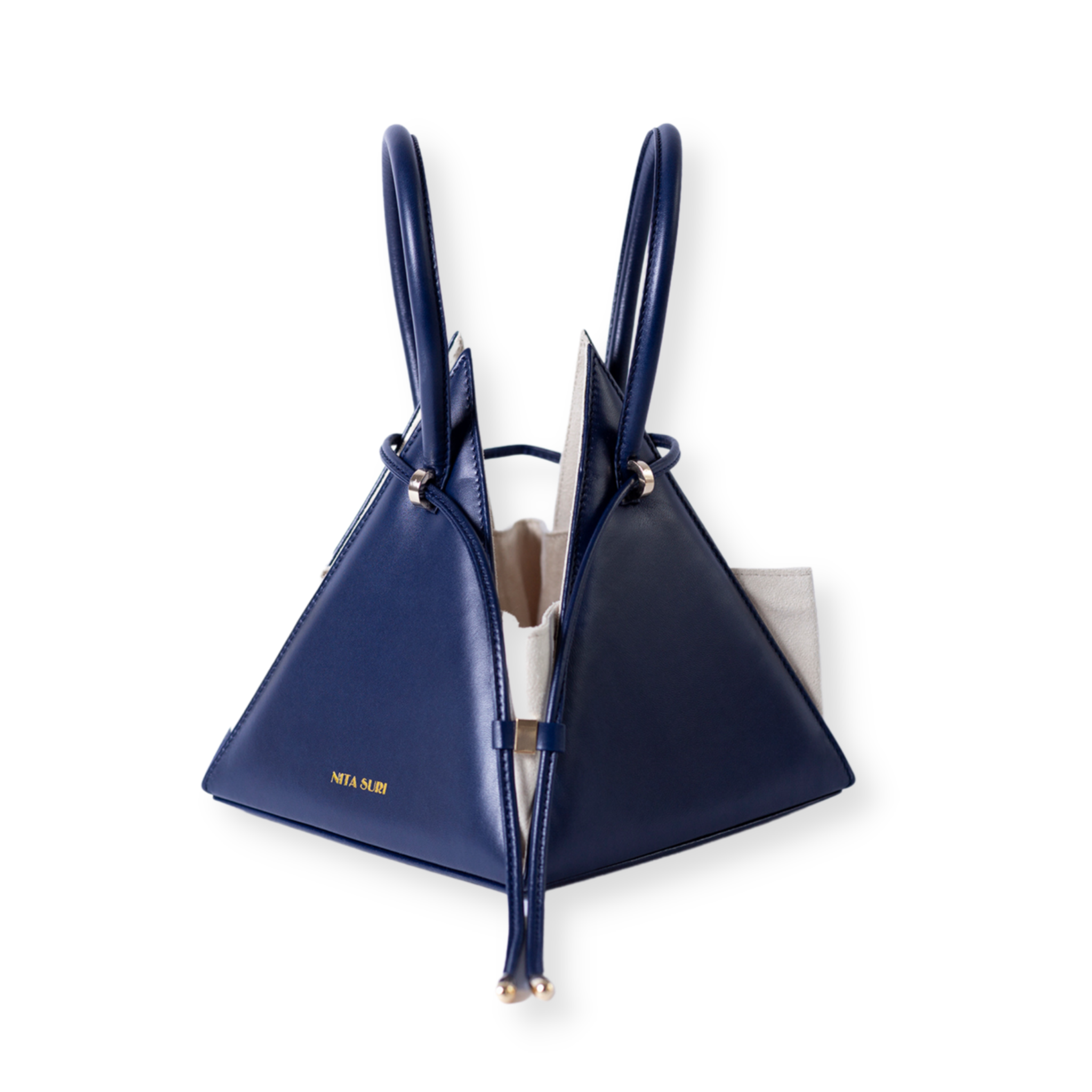 Buy now the Iconic Lia Handbag inspired by the geometric shapes of our designer's birth city Barcelona, and its world known artist, Antonio Gaudí, architect of the world wonder La Sagrada Familia. The Iconic Lia Ocean Blue Handbag has a unique and functional pyramidal design able to fit all your essentials. 