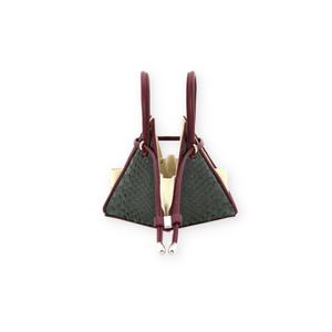 Buy now the Exotic LIA Mini bag inspired by the geometric shapes of our designer's birth city Barcelona, and its world known artist, Antonio Gaudí, architect of the world wonder La Sagrada Familia. The Iconic Lia Green & Burgundy Mini bag has a unique and functional pyramidal design able to fit all your essentials. 