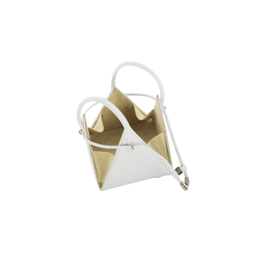 Buy now the Iconic LIA Mini bag inspired by the geometric shapes of our designer's birth city Barcelona, and its world known artist, Antonio Gaudí, architect of the world wonder La Sagrada Familia. The Iconic Lia White Mini bag has a unique and functional pyramidal design able to fit all your essentials.