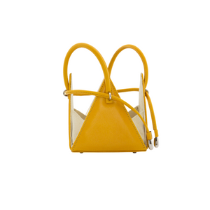 Buy now the Iconic Lia Handbag inspired by the geometric shapes of our designer's birth city Barcelona, and its world known artist, Antonio Gaudí, architect of the world wonder La Sagrada Familia. The Iconic Lia Amber Mini bag has a unique and functional pyramidal design able to fit all your essentials. 