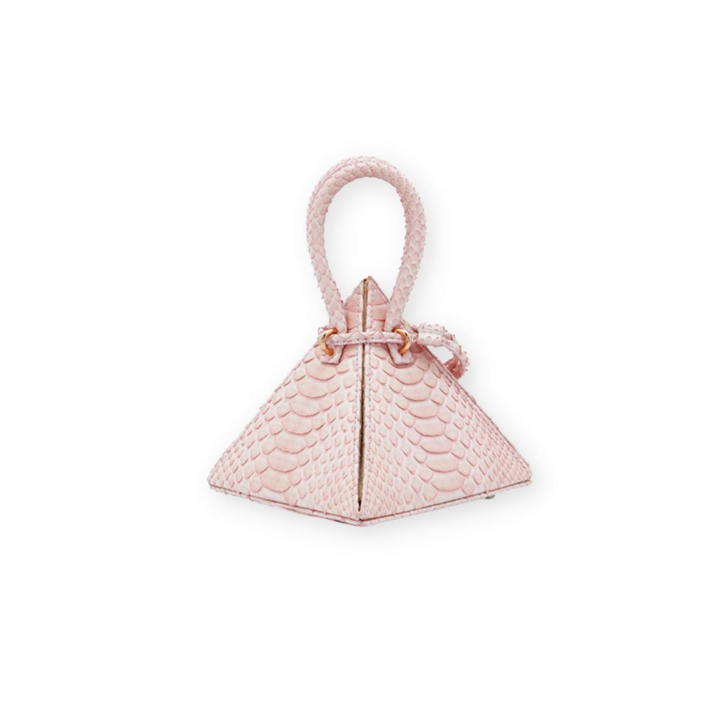 Buy now the Exotic LIA Mini bag inspired by the geometric shapes of our designer's birth city Barcelona, and its world known artist, Antonio Gaudí, architect of the world wonder La Sagrada Familia. The Exotic Lia Python Pastel Pink Mini bag has a unique and functional pyramidal design able to fit all your essentials.