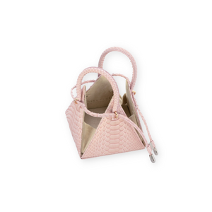 Buy now the Exotic LIA Mini bag inspired by the geometric shapes of our designer's birth city Barcelona, and its world known artist, Antonio Gaudí, architect of the world wonder La Sagrada Familia. The Exotic Lia Python Pastel Pink Mini bag has a unique and functional pyramidal design able to fit all your essentials.