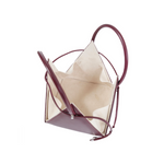 Buy now the Iconic LIA Mini bag inspired by the geometric shapes of our designer's birth city Barcelona, and its world known artist, Antonio Gaudí, architect of the world wonder La Sagrada Familia. The Iconic Lia Burgundy Mini bag has a unique and functional pyramidal design able to fit all your essentials. 