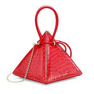 Buy now the Exotic Lia Handbag inspired by the geometric shapes of our designer's birth city Barcelona, and its world known artist, Antonio Gaudí, architect of the world wonder La Sagrada Familia. The Exotic Lia Croc-Embossed Passion Red Handbag has a unique and functional pyramidal design able to fit all your essentials. 