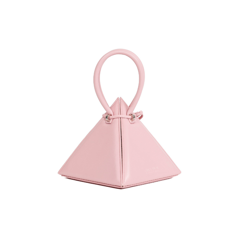 Buy now the Iconic LIA Mini bag inspired by the geometric shapes of our designer's birth city Barcelona, and its world known artist, Antonio Gaudí, architect of the world wonder La Sagrada Familia. The Iconic Lia Pink Mini bag has a unique and functional pyramidal design able to fit all your essentials. 