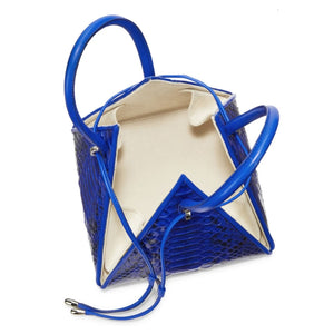 Buy now the Exotic Lia Handbag inspired by the geometric shapes of our designer's birth city Barcelona, and its world known artist, Antonio Gaudí, architect of the world wonder La Sagrada Familia. The Exotic Lia Electric Blue Handbag has a unique and functional pyramidal design able to fit all your essentials. 