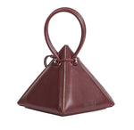 Buy now the Iconic Lia Handbag inspired by the geometric shapes of our designer's birth city Barcelona, and its world known artist, Antonio Gaudí, architect of the world wonder La Sagrada Familia. The Iconic Lia Burgundy Handbag has a unique and functional pyramidal design able to fit all your essentials.