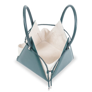 Buy now the Iconic Lia Handbag inspired by the geometric shapes of our designer's birth city Barcelona, and its world known artist, Antonio Gaudí, architect of the world wonder La Sagrada Familia. The Iconic Lia Cipresso Green Handbag has a unique and functional pyramidal design able to fit all your essentials. 
