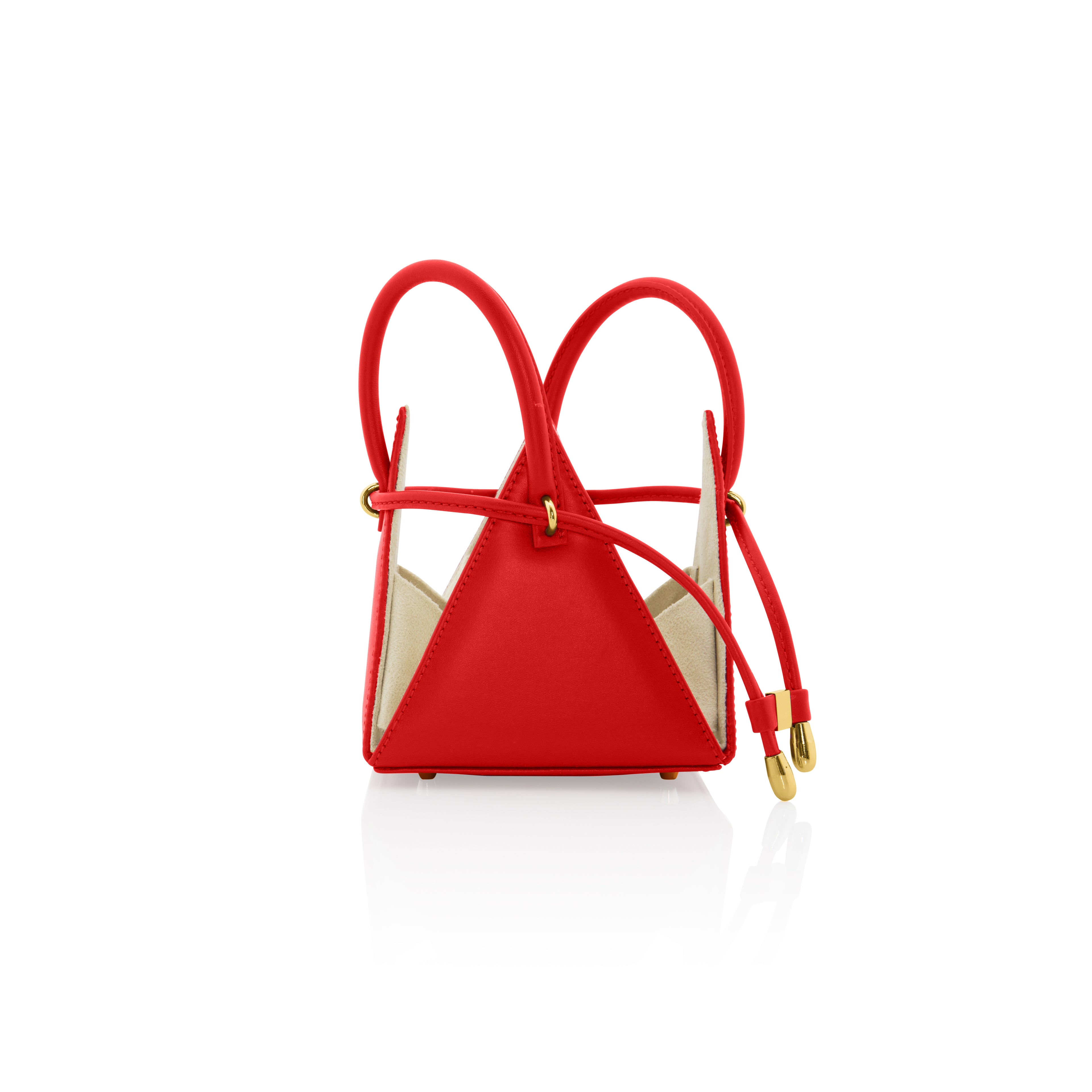 Buy now the Iconic LIA Mini bag inspired by the geometric shapes of our designer's birth city Barcelona, and its world known artist, Antonio Gaudí, architect of the world wonder La Sagrada Familia. The Iconic Lia Red Mini bag has a unique and functional pyramidal design able to fit all your essentials. 