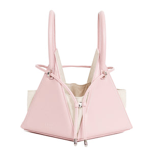 Buy now the Iconic Lia Handbag inspired by the geometric shapes of our designer's birth city Barcelona, and its world known artist, Antonio Gaudí, architect of the world wonder La Sagrada Familia. The Iconic Lia Pink Handbag has a unique and functional pyramidal design able to fit all your essentials. 