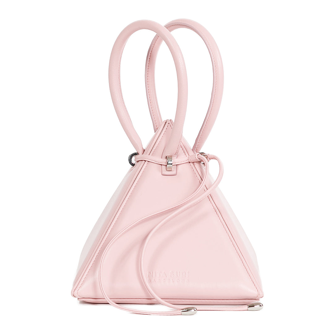 Buy now the Iconic Lia Handbag inspired by the geometric shapes of our designer's birth city Barcelona, and its world known artist, Antonio Gaudí, architect of the world wonder La Sagrada Familia. The Iconic Lia Pink Handbag has a unique and functional pyramidal design able to fit all your essentials. 