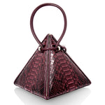 Buy now the Exotic Lia Handbag inspired by the geometric shapes of our designer's birth city Barcelona, and its world known artist, Antonio Gaudí, architect of the world wonder La Sagrada Familia. The Exotic Lia Python Burgundy Handbag has a unique and functional pyramidal design able to fit all your essentials. 