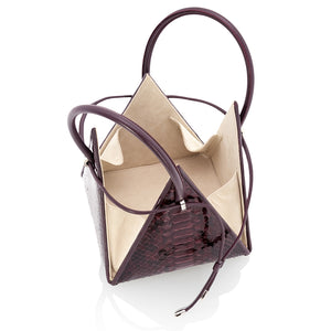 Buy now the Exotic Lia Handbag inspired by the geometric shapes of our designer's birth city Barcelona, and its world known artist, Antonio Gaudí, architect of the world wonder La Sagrada Familia. The Exotic Lia Python Burgundy Handbag has a unique and functional pyramidal design able to fit all your essentials. 