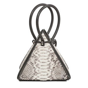 Buy now the Exotic Lia Handbag inspired by the geometric shapes of our designer's birth city Barcelona, and its world known artist, Antonio Gaudí, architect of the world wonder La Sagrada Familia. The Iconic Lia Python Natural Handbag has a unique and functional pyramidal design able to fit all your essentials. 