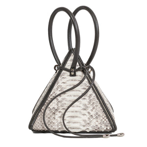 Buy now the Exotic Lia Handbag inspired by the geometric shapes of our designer's birth city Barcelona, and its world known artist, Antonio Gaudí, architect of the world wonder La Sagrada Familia. The Iconic Lia Python Natural Handbag has a unique and functional pyramidal design able to fit all your essentials. 