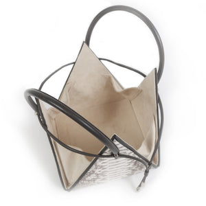 Buy now the Exotic Lia Handbag inspired by the geometric shapes of our designer's birth city Barcelona, and its world known artist, Antonio Gaudí, architect of the world wonder La Sagrada Familia. The Iconic Lia Python Natural Handbag has a unique and functional pyramidal design able to fit all your essentials. 