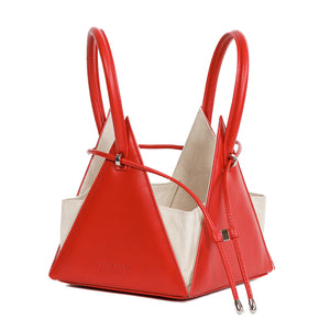 Buy now the Iconic Lia Handbag inspired by the geometric shapes of our designer's birth city Barcelona, and its world known artist, Antonio Gaudí, architect of the world wonder La Sagrada Familia. The Iconic Lia Red Handbag has a unique and functional pyramidal design able to fit all your essentials.