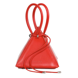 Buy now the Iconic Lia Handbag inspired by the geometric shapes of our designer's birth city Barcelona, and its world known artist, Antonio Gaudí, architect of the world wonder La Sagrada Familia. The Iconic Lia Red Handbag has a unique and functional pyramidal design able to fit all your essentials.