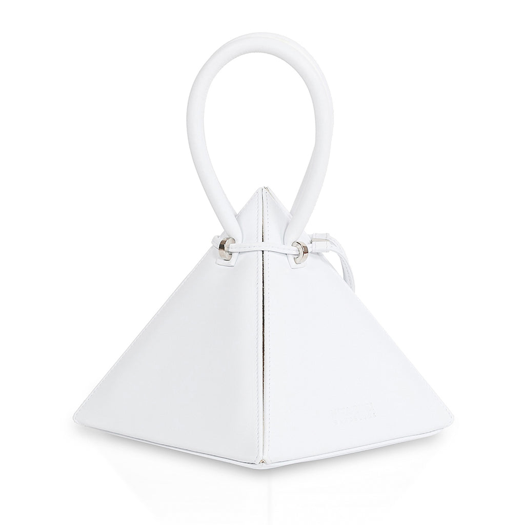 Buy now the Iconic Lia Handbag inspired by the geometric shapes of our designer's birth city Barcelona, and its world known artist, Antonio Gaudí, architect of the world wonder La Sagrada Familia. The Iconic Lia White Handbag has a unique and functional pyramidal design able to fit all your essentials. 