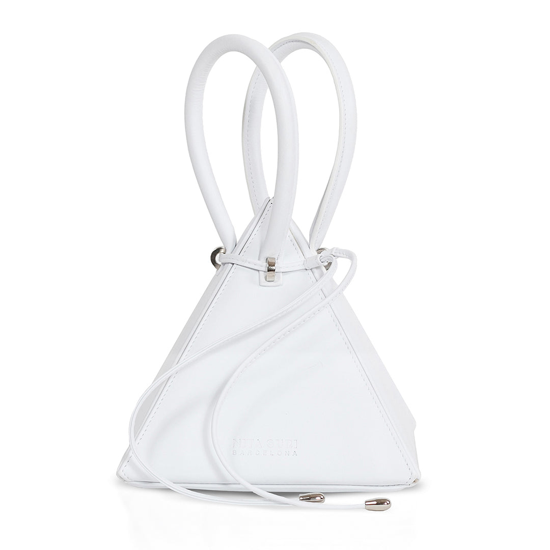 Buy now the Iconic Lia Handbag inspired by the geometric shapes of our designer's birth city Barcelona, and its world known artist, Antonio Gaudí, architect of the world wonder La Sagrada Familia. The Iconic Lia White Handbag has a unique and functional pyramidal design able to fit all your essentials. 