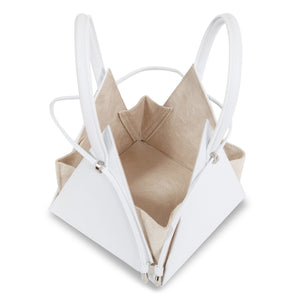 Buy now the Iconic Lia Handbag inspired by the geometric shapes of our designer's birth city Barcelona, and its world known artist, Antonio Gaudí, architect of the world wonder La Sagrada Familia. The Iconic Lia White Handbag has a unique and functional pyramidal design able to fit all your essentials. 