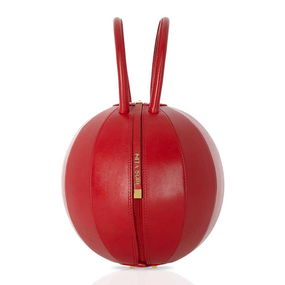 Buy now the Iconic Pilo Handbag inspired by the geometric shapes of our designer's birth city Barcelona, and its world known artist, Antonio Gaudí, architect of the world wonder La Sagrada Familia. The Iconic Pilo Red Handbag has a unique and functional sphere design able to fit all your essentials. 