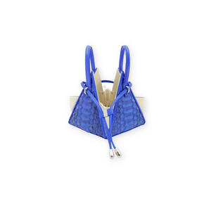 Buy now the Exotic LIA Mini bag inspired by the geometric shapes of our designer's birth city Barcelona, and its world known artist, Antonio Gaudí, architect of the world wonder La Sagrada Familia. The Exotic Lia Electric Blue Mini bag has a unique and functional pyramidal design able to fit all your essentials. 