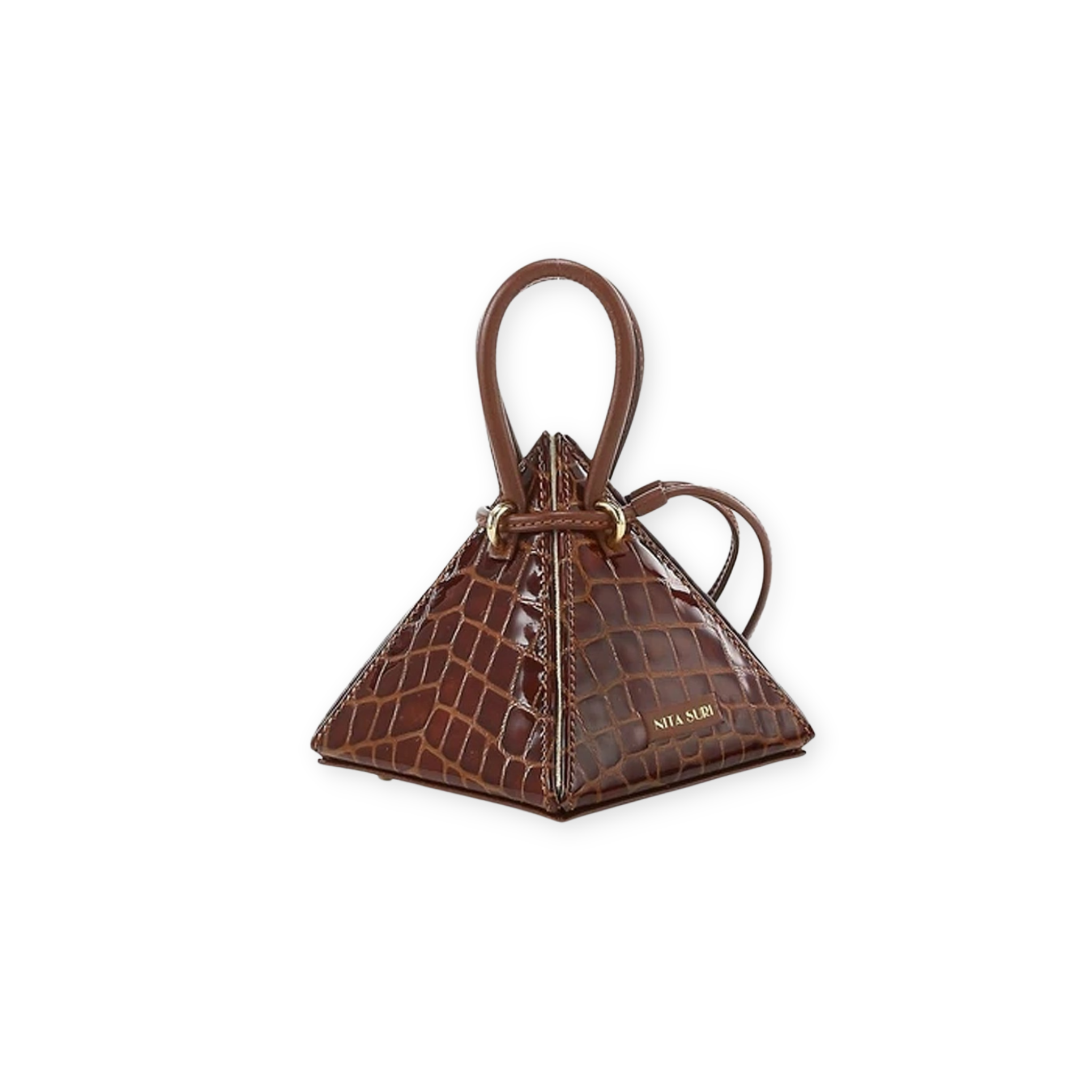 Buy now the Exotic LIA Mini bag inspired by the geometric shapes of our designer's birth city Barcelona, and its world known artist, Antonio Gaudí, architect of the world wonder La Sagrada Familia. The Lia Croc-Embossed Cuero Brown Exotic Mini bag has a unique and functional pyramidal design able to fit all your essentials. 
