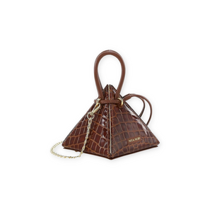 Buy now the Exotic LIA Mini bag inspired by the geometric shapes of our designer's birth city Barcelona, and its world known artist, Antonio Gaudí, architect of the world wonder La Sagrada Familia. The Lia Croc-Embossed Cuero Brown Exotic Mini bag has a unique and functional pyramidal design able to fit all your essentials. 