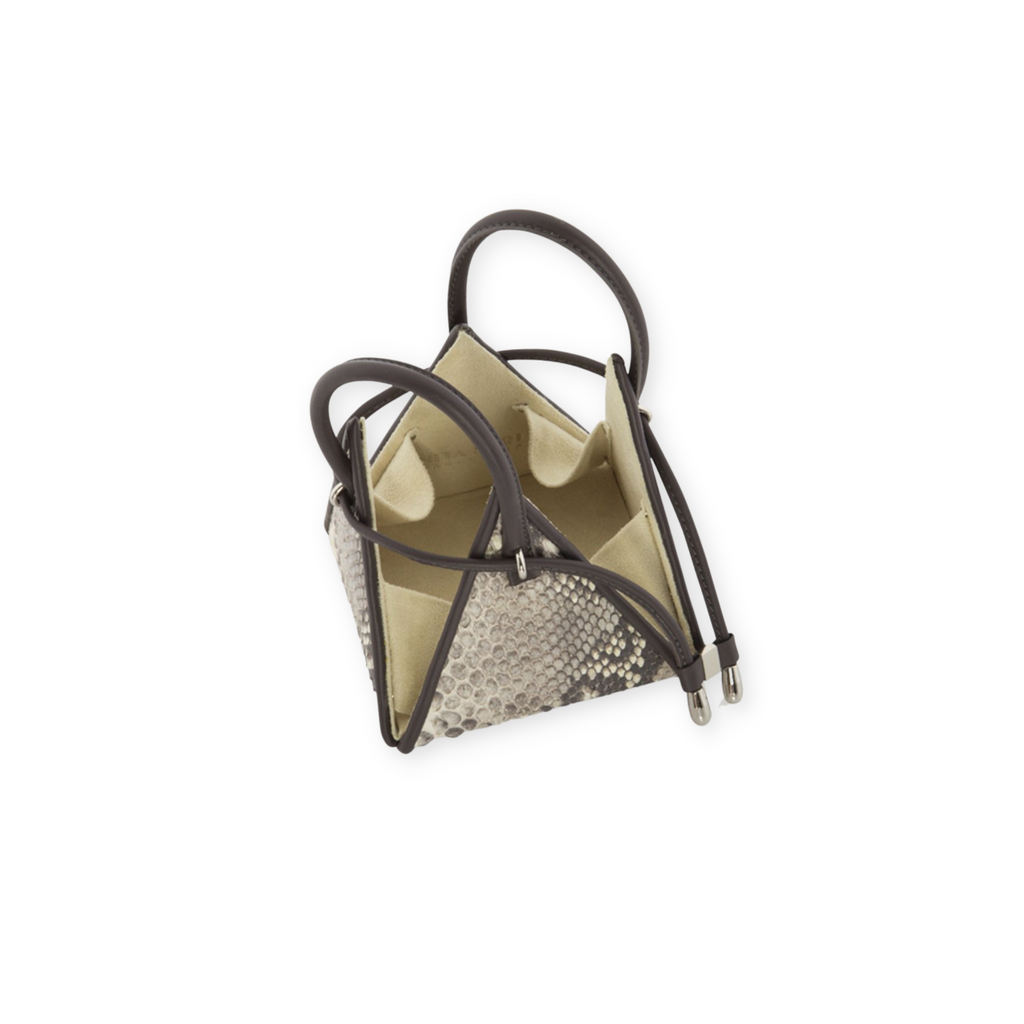 Buy now the Exotic LIA Mini bag inspired by the geometric shapes of our designer's birth city Barcelona, and its world known artist, Antonio Gaudí, architect of the world wonder La Sagrada Familia. The Exotic Lia Python Natural Mini bag has a unique and functional pyramidal design able to fit all your essentials. 