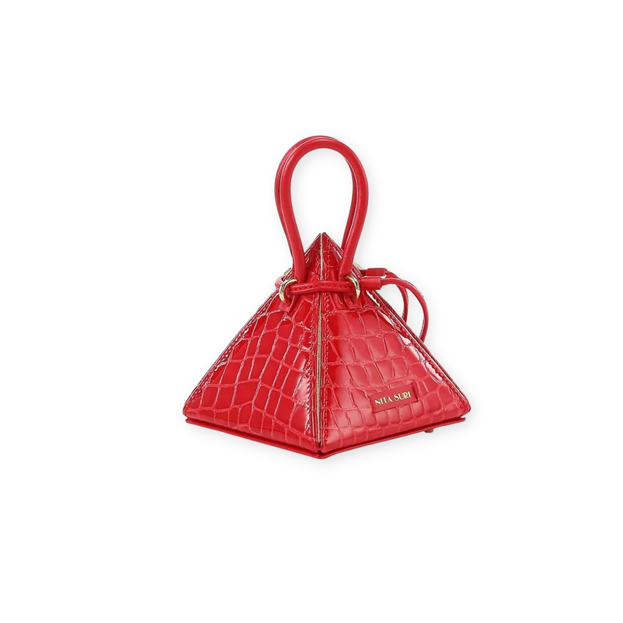 Buy now the Exotic LIA Mini bag inspired by the geometric shapes of our designer's birth city Barcelona, and its world known artist, Antonio Gaudí, architect of the world wonder La Sagrada Familia. The Exotic Lia Croc-Embossed Passion Red Mini bag has a unique and functional pyramidal design able to fit all your essentials. 
