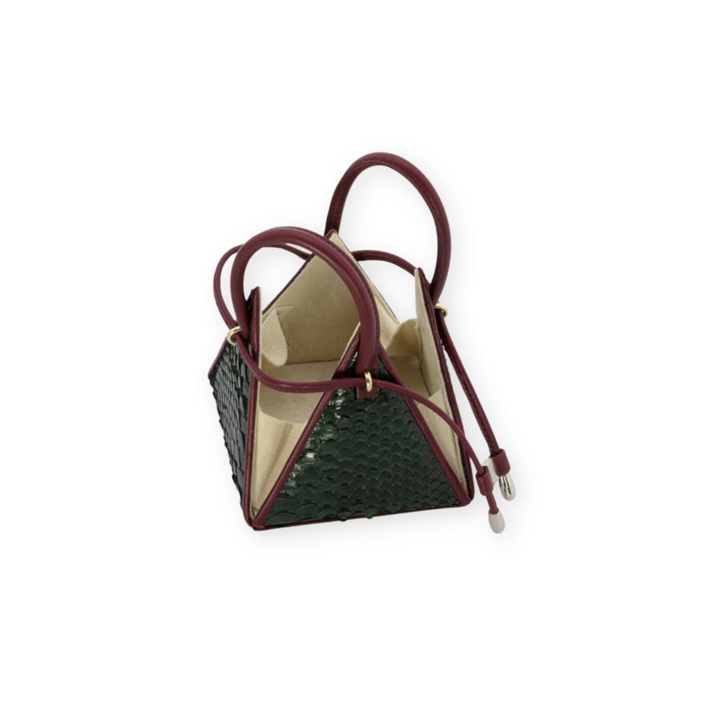 Buy now the Exotic LIA Mini bag inspired by the geometric shapes of our designer's birth city Barcelona, and its world known artist, Antonio Gaudí, architect of the world wonder La Sagrada Familia. The Iconic Lia Green & Burgundy Mini bag has a unique and functional pyramidal design able to fit all your essentials. 