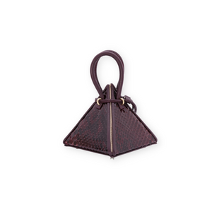 Buy now the Exotic LIA Mini bag inspired by the geometric shapes of our designer's birth city Barcelona, and its world known artist, Antonio Gaudí, architect of the world wonder La Sagrada Familia. The Exotic Lia Python Burgundy Mini bag has a unique and functional pyramidal design able to fit all your essentials. 