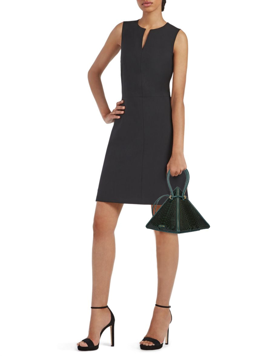 Buy now the Exotic Lia Handbag inspired by the geometric shapes of our designer's birth city Barcelona, and its world known artist, Antonio Gaudí, architect of the world wonder La Sagrada Familia. The Exotic Lia Croc-Embossed Pino Green Handbag has a unique and functional pyramidal design able to fit all your essentials. 