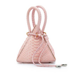 Buy now the Exotic Lia Handbag inspired by the geometric shapes of our designer's birth city Barcelona, and its world known artist, Antonio Gaudí, architect of the world wonder La Sagrada Familia. The Iconic Lia Python Pastel Pink Handbag has a unique and functional pyramidal design able to fit all your essentials. 